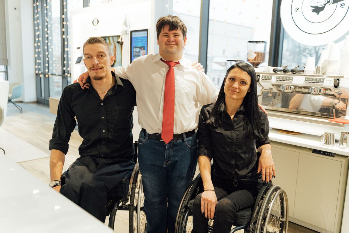A group of friends of mixed abilities together at a cafe